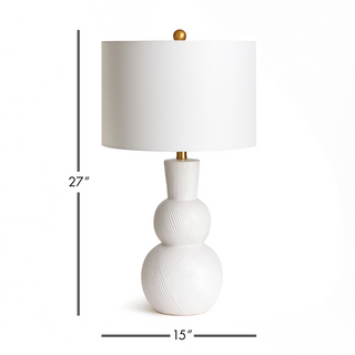 In a classic clean white ceramic with hand carved markings along the body, this lamp is made for the traditional setting. A generally scaled white linen shade &amp; simple brass finial finish off the look.Max wattage: 100W;-Socket: E26
Third & Main, Home Decor, Lighting, Table Lamp, Side Table Lamp, Contemporary Lighting, Luxury Home, Luxury Lighting, Hand Carved Detail